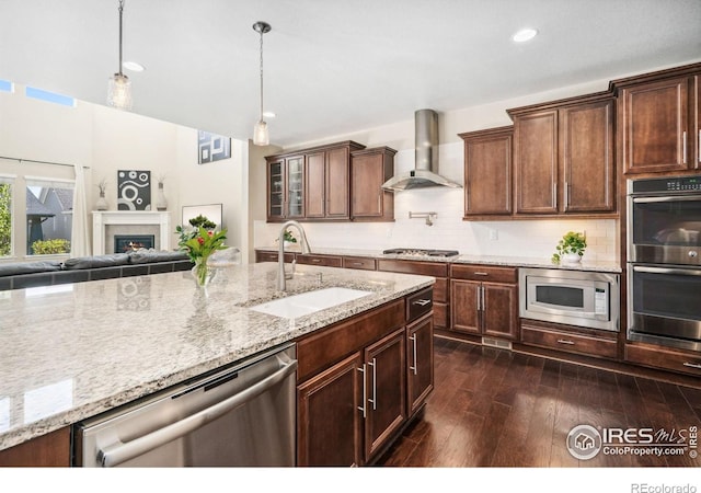 2150 Blue Yonder Way, Fort Collins, CO 80525 - kitchen featuring appliances with stainless steel finishes, wall chimney range hood, a sink, open floor plan, and dark wood-style floors