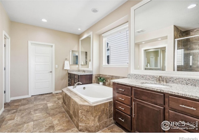 2150 Blue Yonder Way, Fort Collins, CO 80525 - bathroom featuring a stall shower, a garden tub, baseboards, two vanities, and recessed lighting