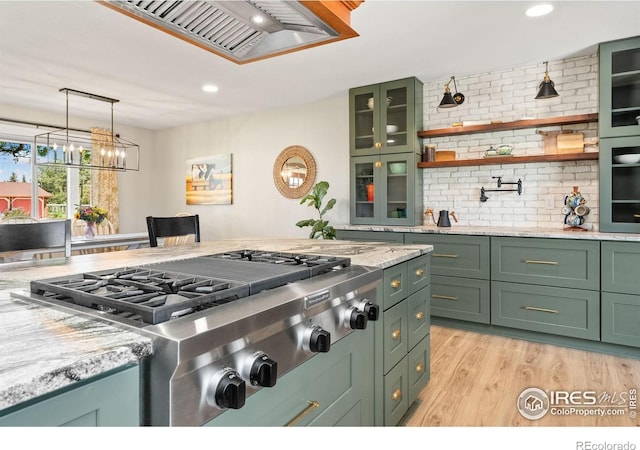kitchen with green cabinetry, stainless steel gas cooktop, light wood-style floors, light stone countertops, and recessed lighting