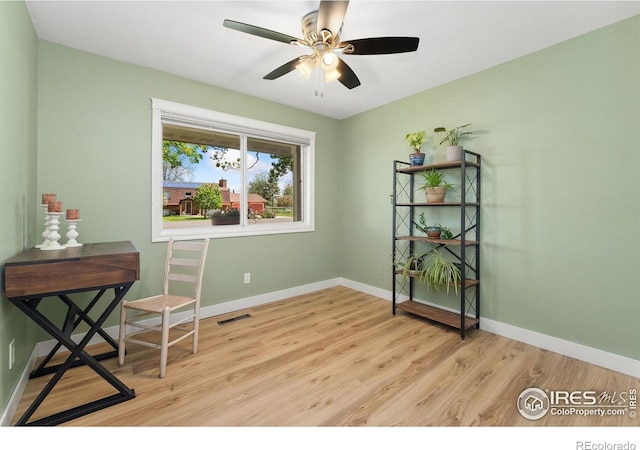unfurnished room with wood finished floors, ceiling fan, and baseboards
