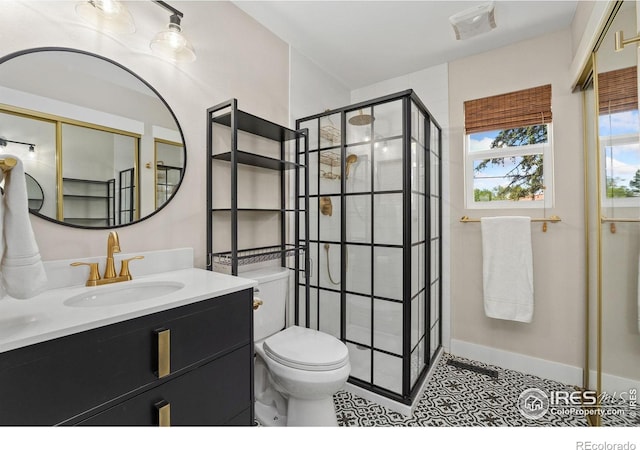 bathroom with a stall shower, toilet, vanity, and tile patterned flooring