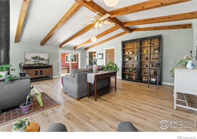 living area featuring light wood finished floors, ceiling fan, and baseboards