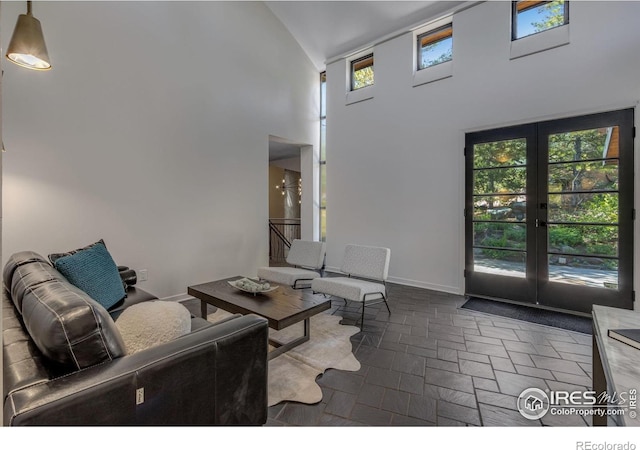 505 Geneva Ave, Boulder, CO 80302 - living room with high vaulted ceiling, french doors, healthy amount of natural light, and baseboards