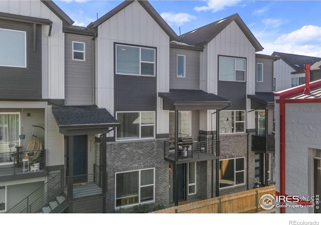 multi unit property with board and batten siding, fence, and brick siding