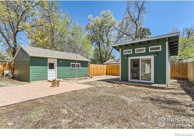 1136 Venice St, Longmont, CO 80501 - back of property featuring an outdoor structure and a fenced backyard