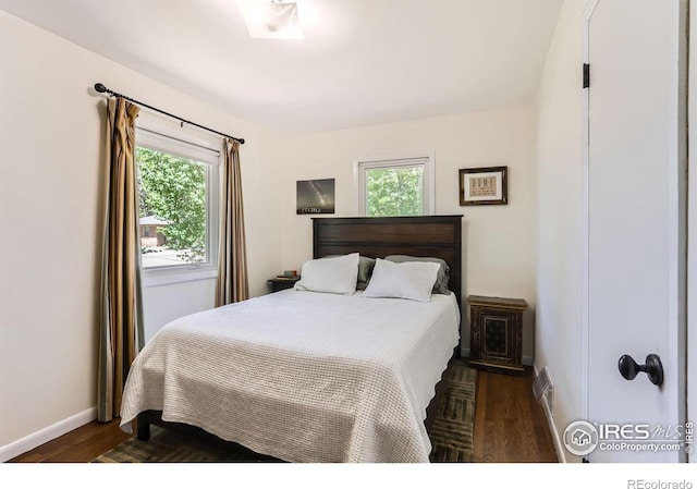 1136 Venice St, Longmont, CO 80501 - bedroom with dark wood-style floors and baseboards