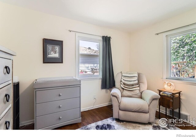 1136 Venice St, Longmont, CO 80501 - sitting room with dark wood-style floors and baseboards