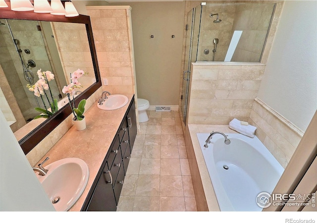 full bath featuring a shower stall, a garden tub, double vanity, and toilet