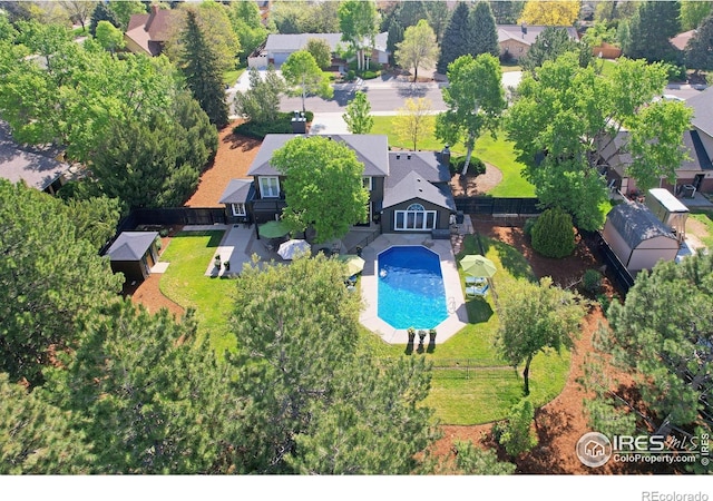 aerial perspective of suburban area featuring a pool area