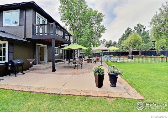 view of patio featuring a balcony and a grill