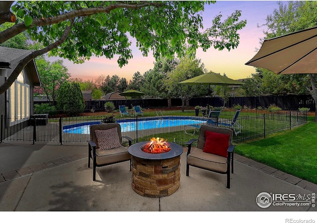 view of pool with an outdoor fire pit and a patio