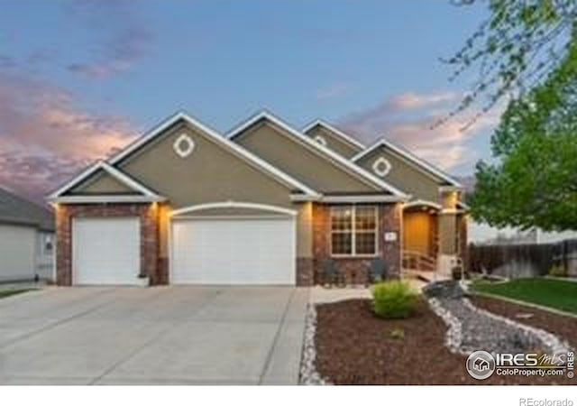 traditional-style house featuring a garage and driveway