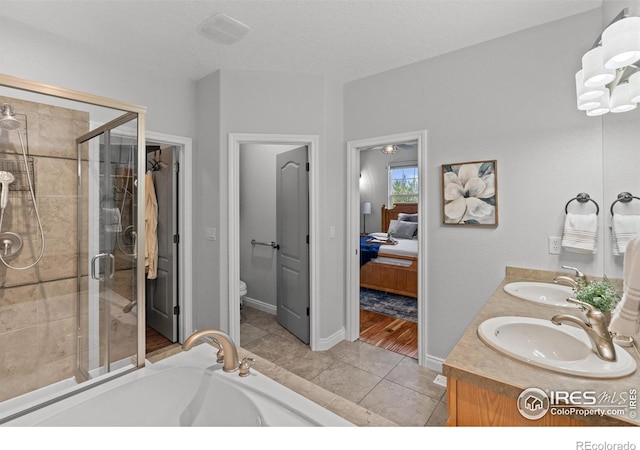 full bathroom featuring a stall shower, toilet, double vanity, connected bathroom, and a bathtub