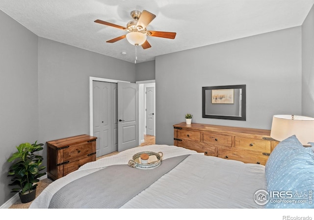 bedroom featuring a ceiling fan, a closet, and baseboards
