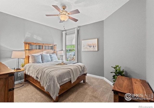 carpeted bedroom with baseboards and a ceiling fan