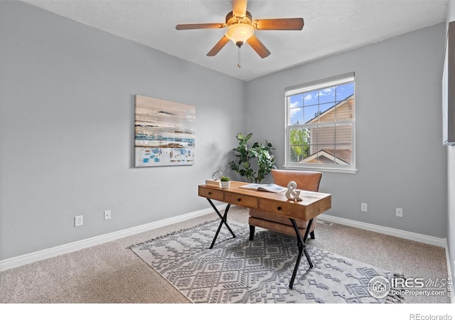 office area with carpet flooring, baseboards, and a ceiling fan