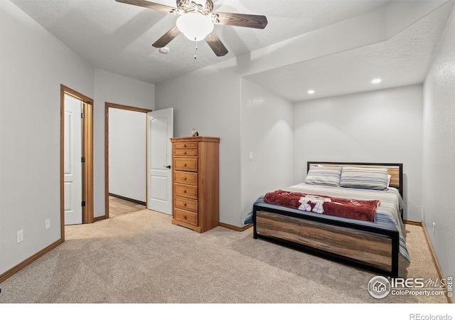 bedroom with light colored carpet and baseboards
