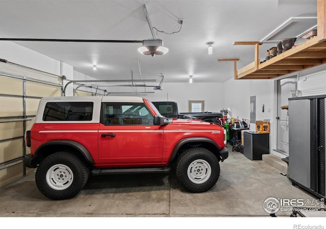 garage with a garage door opener and electric panel