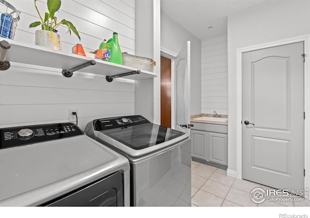 clothes washing area featuring independent washer and dryer and light tile patterned floors
