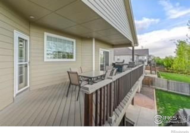 wooden deck featuring outdoor dining space