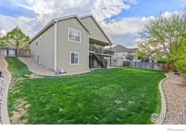 rear view of property featuring stairs