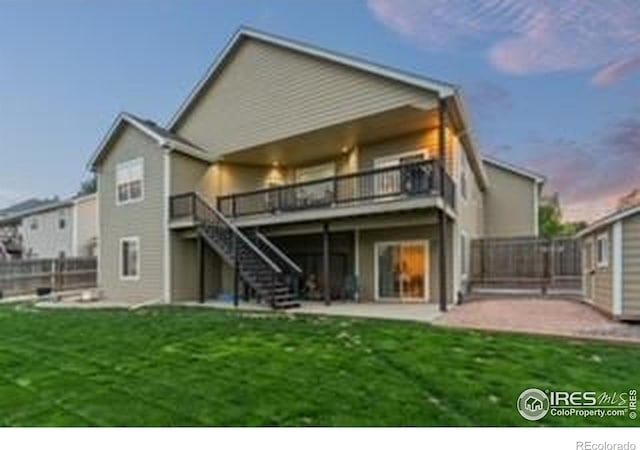 rear view of house featuring a patio area, stairway, and a deck