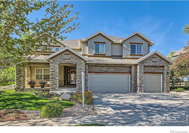 14180 Whitney Cir, Broomfield, CO 80023 - view of front facade with stucco siding, stone siding, driveway, and an attached garage