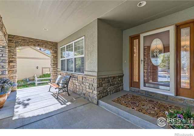 14180 Whitney Cir, Broomfield, CO 80023 - property entrance with a porch, stone siding, and stucco siding