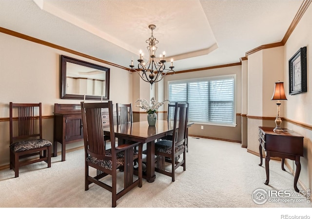 14180 Whitney Cir, Broomfield, CO 80023 - dining space with a chandelier, light colored carpet, ornamental molding, a tray ceiling, and baseboards