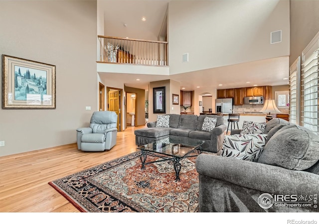 14180 Whitney Cir, Broomfield, CO 80023 - living room with light wood-style floors and a high ceiling