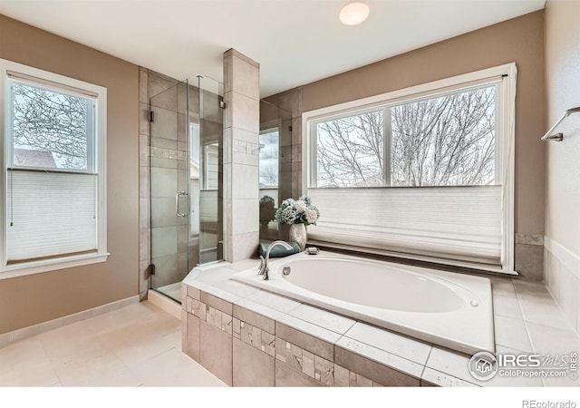 14180 Whitney Cir, Broomfield, CO 80023 - full bath with healthy amount of natural light, a stall shower, a garden tub, and tile patterned floors