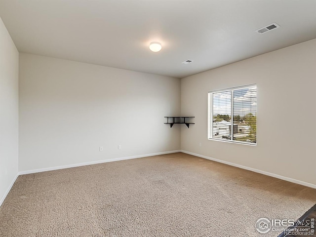 carpeted spare room with baseboards