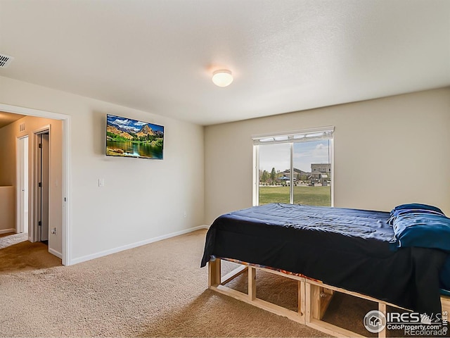 bedroom with carpet flooring and baseboards