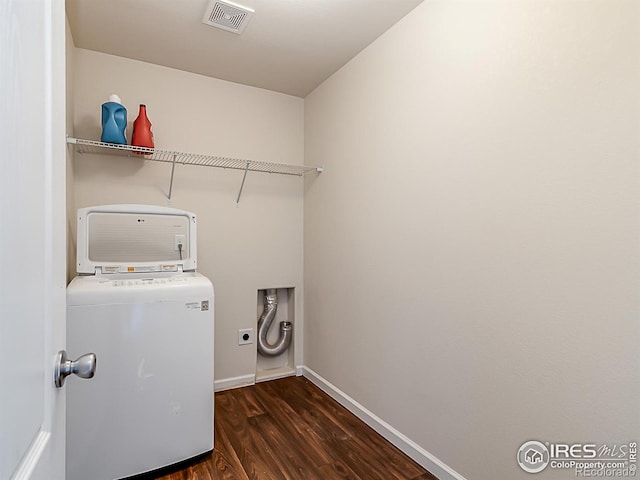 laundry room with wood finished floors, baseboards, and washer / clothes dryer