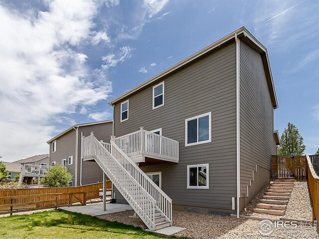 back of house featuring stairs, a patio area, fence, and a wooden deck
