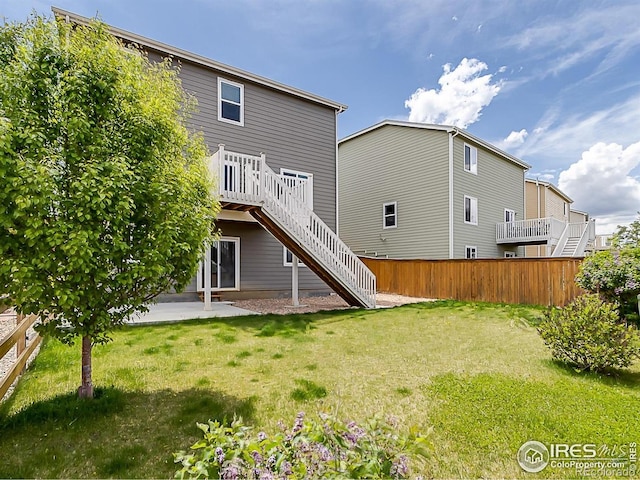 rear view of house with stairs and a deck