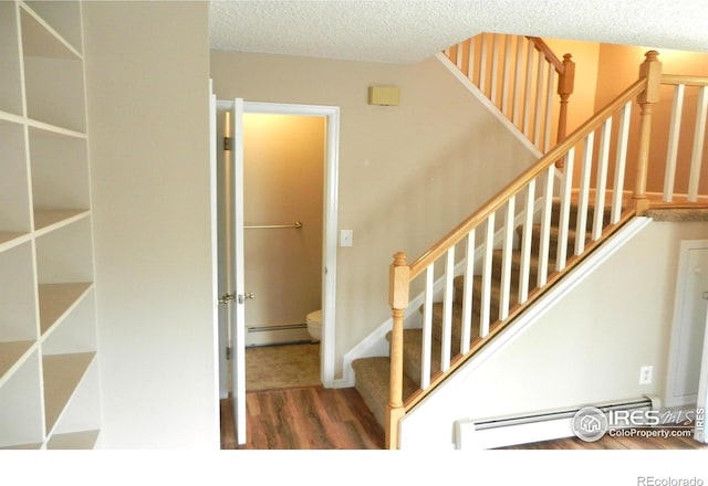 4150 Monroe Dr Unit C, Boulder, CO 80303 - stairs featuring wood finished floors, a textured ceiling, and baseboard heating
