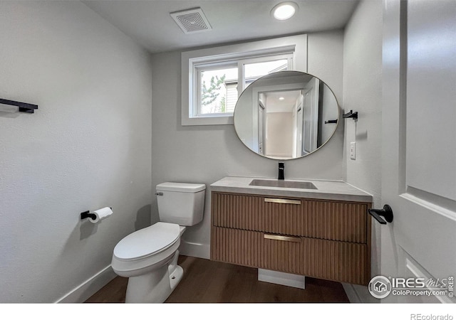 5978 Scotswood Ct, Boulder, CO 80301 - half bathroom featuring wood finished floors, baseboards, toilet, and vanity