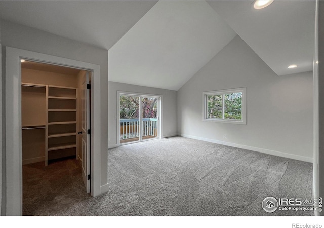 5978 Scotswood Ct, Boulder, CO 80301 - unfurnished bedroom with carpet floors, a spacious closet, baseboards, access to outside, and lofted ceiling