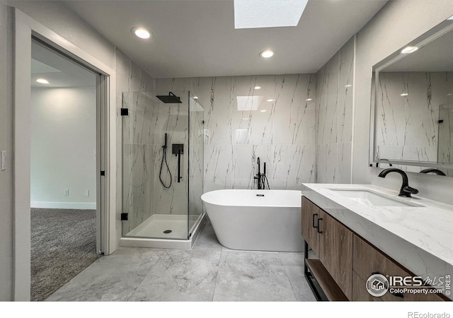 5978 Scotswood Ct, Boulder, CO 80301 - bathroom featuring tile walls, a marble finish shower, marble finish flooring, recessed lighting, and a soaking tub