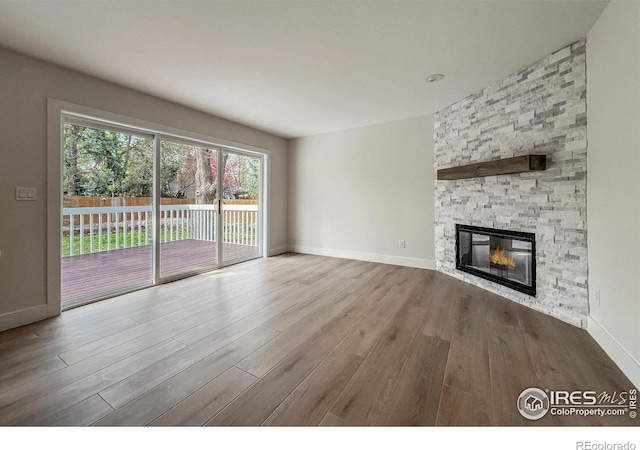 5978 Scotswood Ct, Boulder, CO 80301 - unfurnished living room with wood finished floors, a fireplace, and baseboards