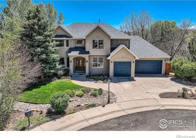 933 Xenon Ct, Golden, CO 80401 - view of front of property with a garage, concrete driveway, stucco siding, fence, and a shingled roof