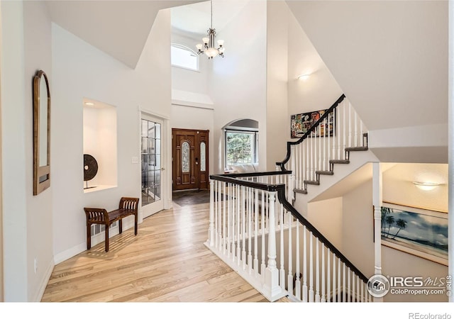 933 Xenon Ct, Golden, CO 80401 - entryway featuring wood finished floors, a chandelier, a high ceiling, baseboards, and stairway
