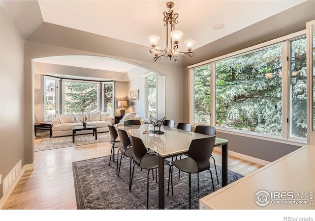 933 Xenon Ct, Golden, CO 80401 - dining space with arched walkways, light wood finished floors, baseboards, and healthy amount of natural light