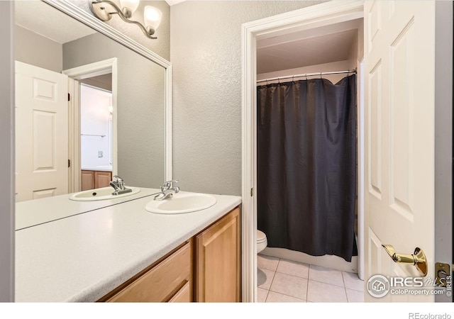 933 Xenon Ct, Golden, CO 80401 - full bathroom with toilet, vanity, tile patterned flooring, a shower with curtain, and a textured wall
