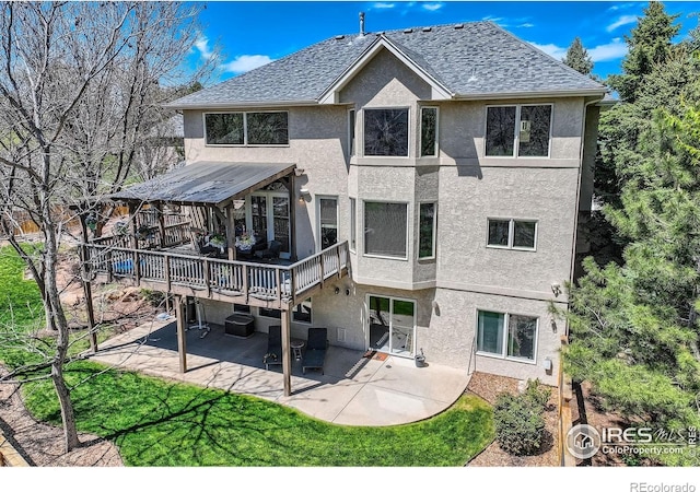 933 Xenon Ct, Golden, CO 80401 - back of house featuring stucco siding, a patio, a wooden deck, and roof with shingles