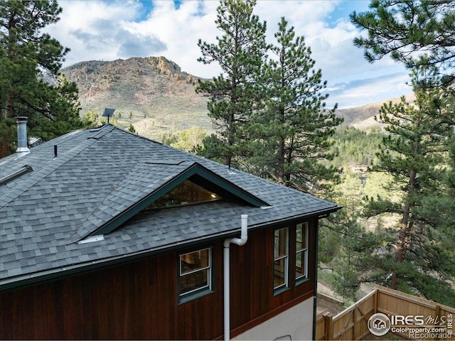 101 Spruce St, Jamestown, CO 80455 - view of property exterior featuring a shingled roof, a mountain view, and fence