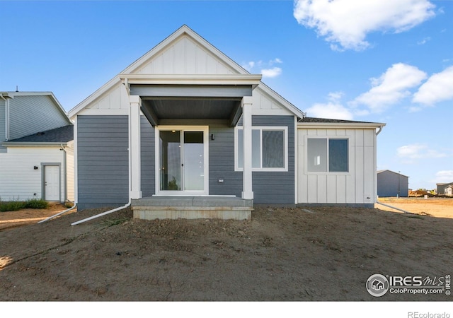 rear view of property with board and batten siding