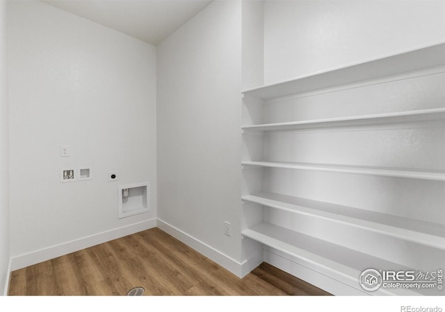 laundry area featuring washer hookup, wood finished floors, hookup for an electric dryer, and baseboards