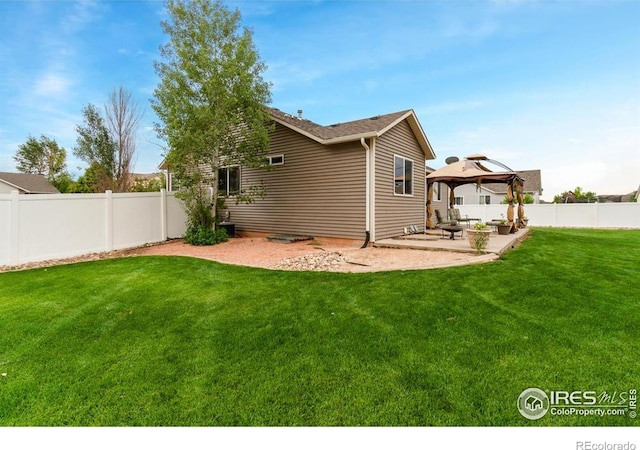 7037 Raleigh St, Wellington, CO 80549 - rear view of property featuring a gazebo and a patio area